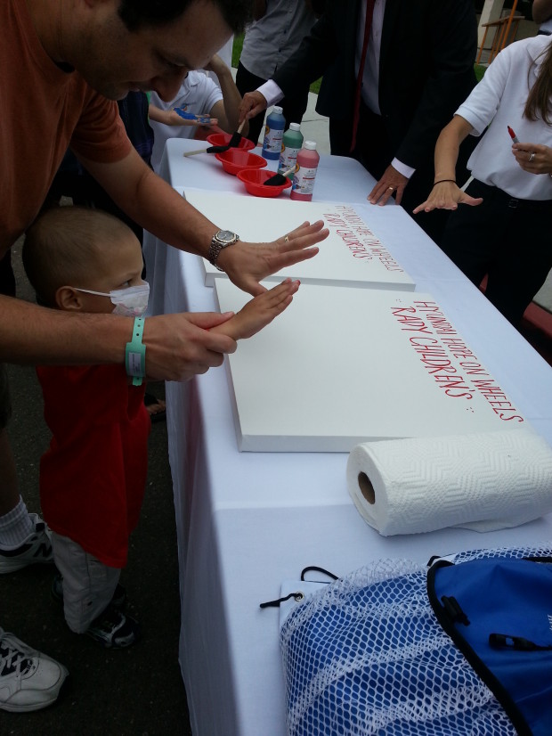 Micah leaves his hand print (with the help of his father Jeff) during the Rady Children’s Hospital's acceptance of the Hyundai's Hope on Wheels award ceremony